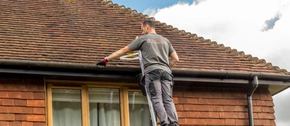 Gutter cleaning a residential property in Ripley